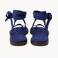 Pair of blue sandals with thin straps on a white background