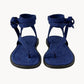 Pair of blue sandals with bow details on a white background