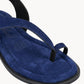 Blue sandal with a black sole on a white background