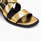 Gold sandal with black straps