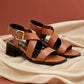 Brown sandals with black soles on a beige fabric background