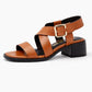 Brown sandal with a black block heel on a white background
